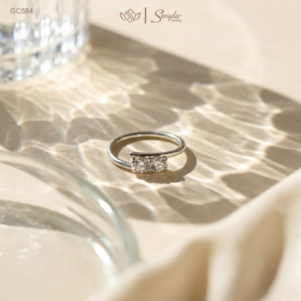 Dainty 925 sterling silver two-stone bypass ring featuring twin brilliant round cubic zirconia gems in a modern Toi et Moi setting.