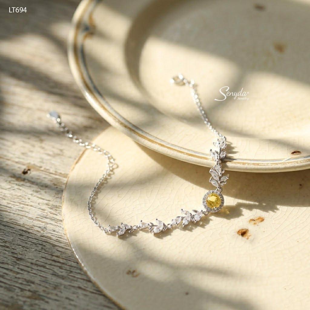 Sterling silver leaf vine bracelet with marquise cubic zirconia leaves and a 5mm halo-set colored CZ center stone