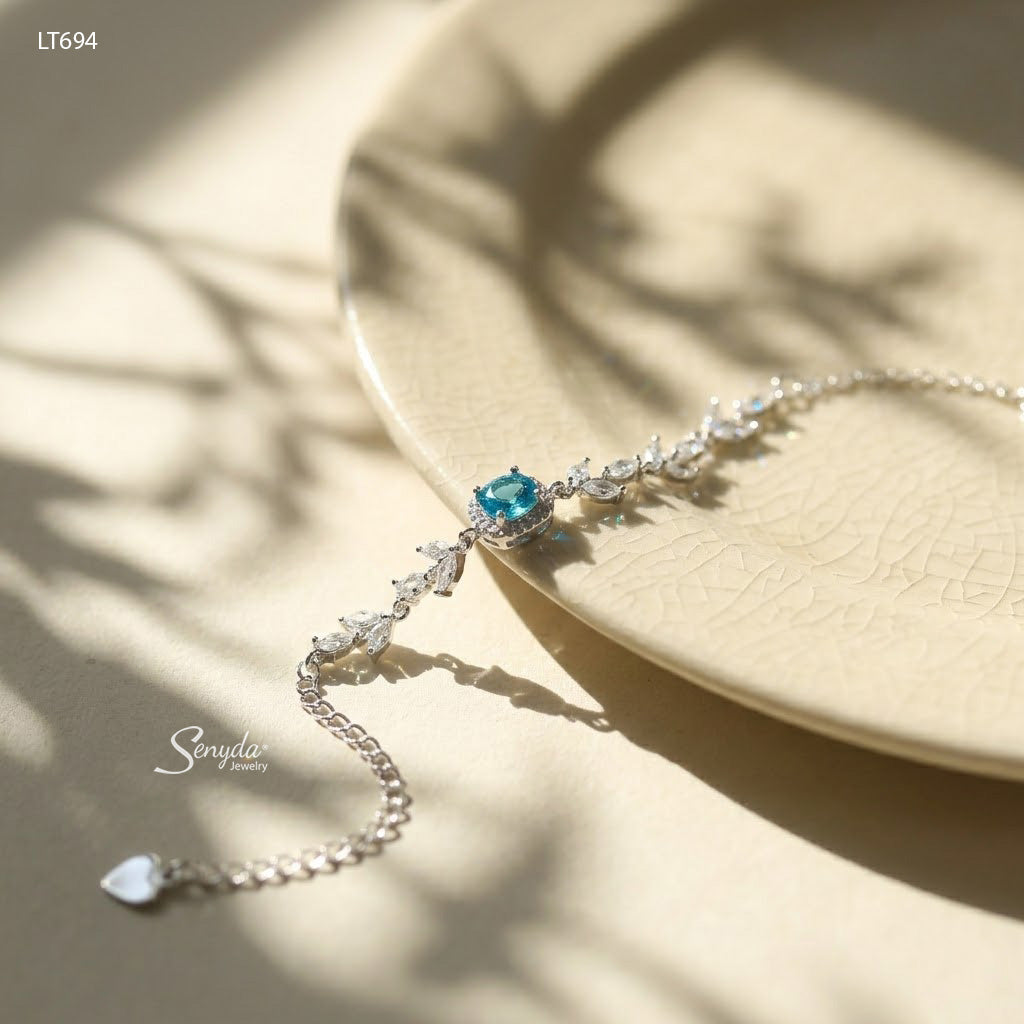 Sterling silver leaf vine bracelet with marquise cubic zirconia leaves and a 5mm halo-set colored CZ center stone