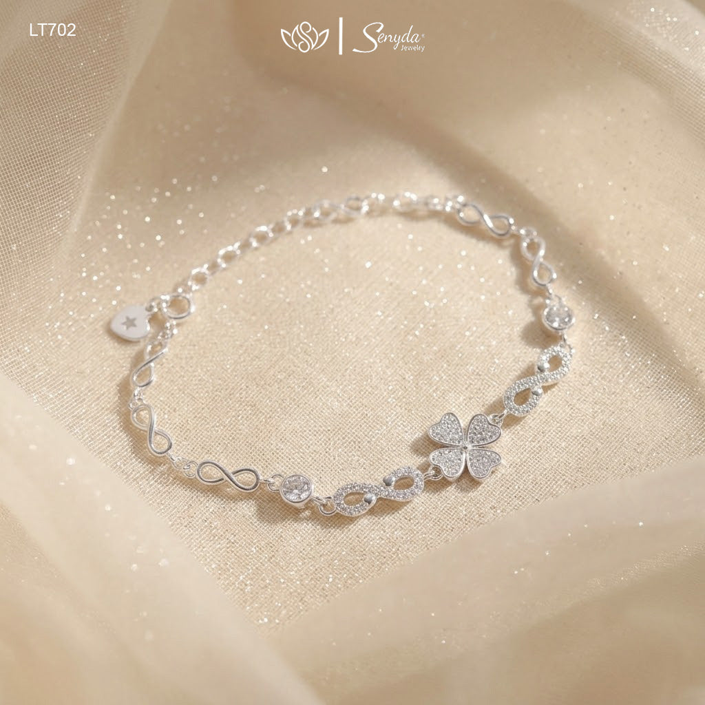 Sterling silver four leaf clover bracelet with pavé cubic zirconia heart leaves and infinity links on shimmering fabric