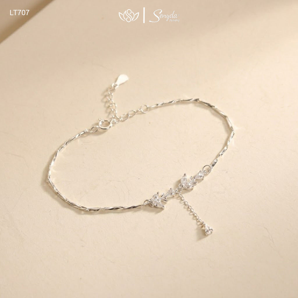 Close-up of a leaf branch bracelet with marquise and pear-cut cubic zirconia on a diamond-cut twisted chain