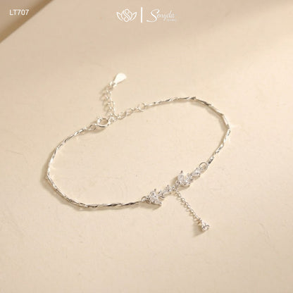 Close-up of a leaf branch bracelet with marquise and pear-cut cubic zirconia on a diamond-cut twisted chain