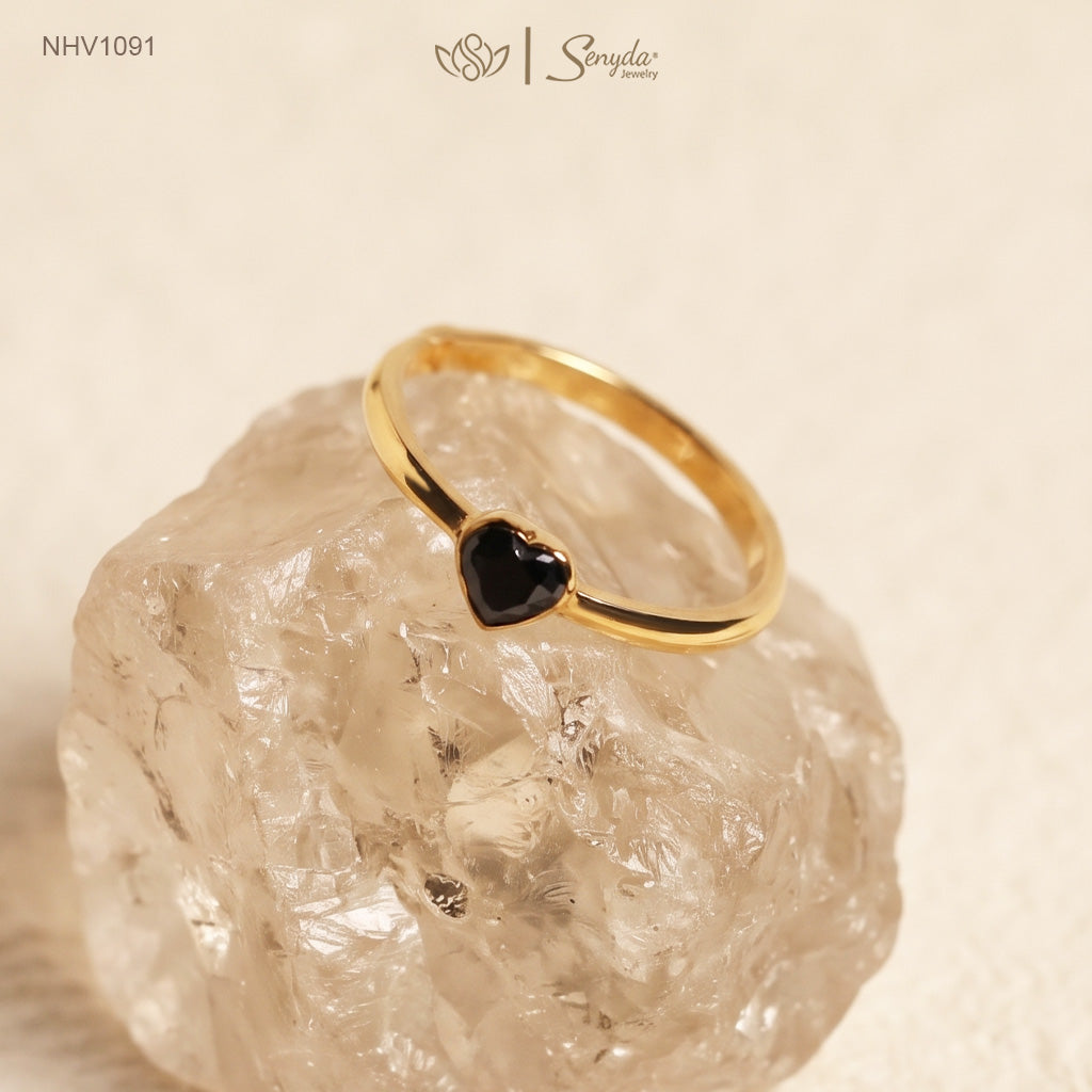 Solid yellow gold ring with a faceted black heart-shaped cubic zirconia in a smooth bezel setting