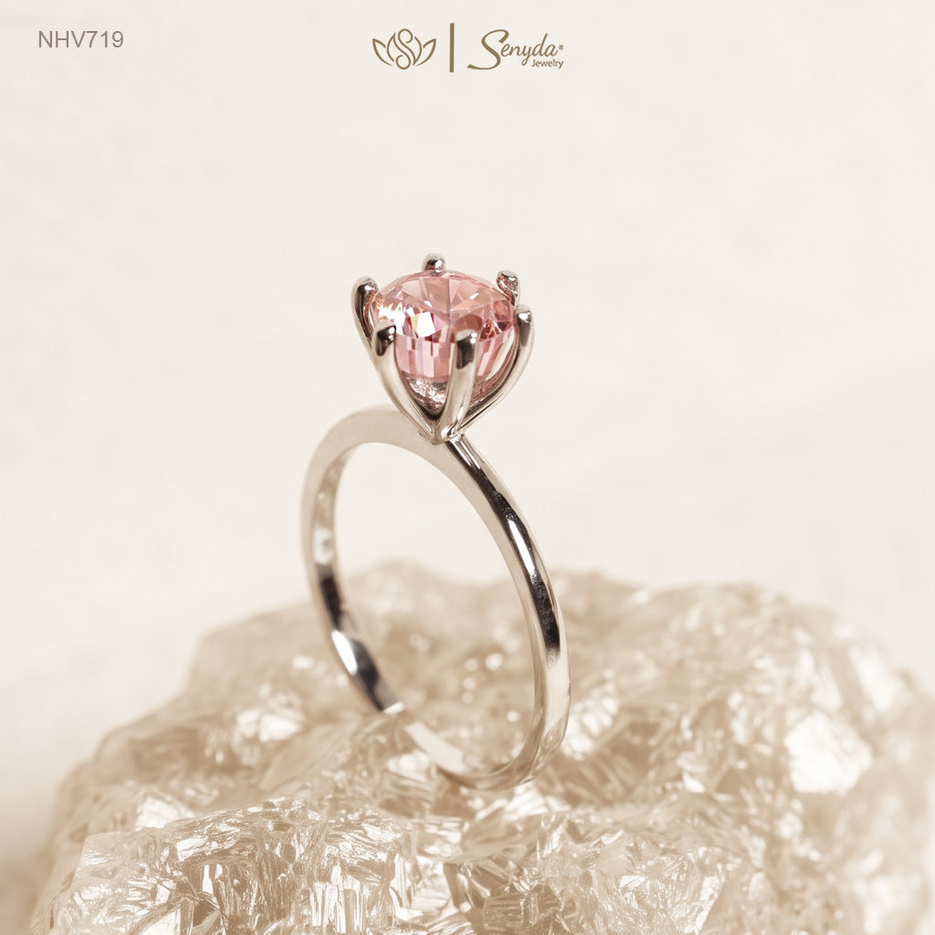 Solid white gold solitaire ring with a 7mm round peach-pink cubic zirconia in a raised six-prong setting