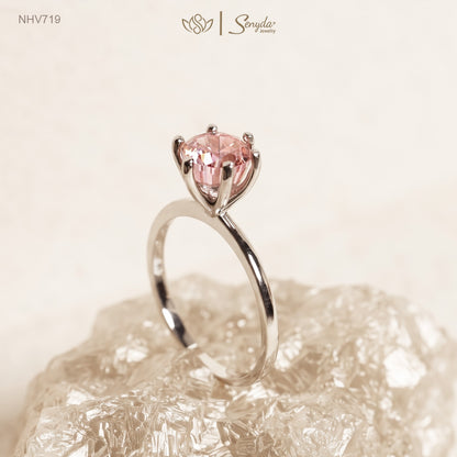 Solid white gold solitaire ring with a 7mm round peach-pink cubic zirconia in a raised six-prong setting
