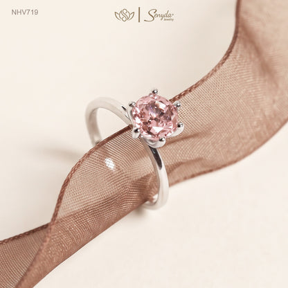 Solid white gold solitaire ring with a 7mm round peach-pink cubic zirconia in a raised six-prong setting