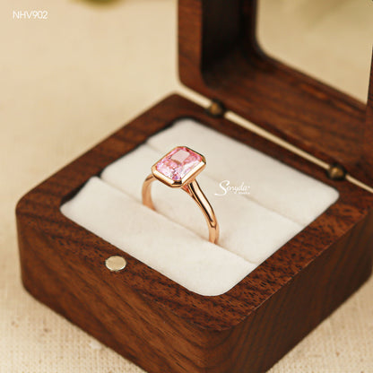Solid yellow gold solitaire ring with a 6x8mm pink radiant-cut cubic zirconia in a smooth bezel setting
