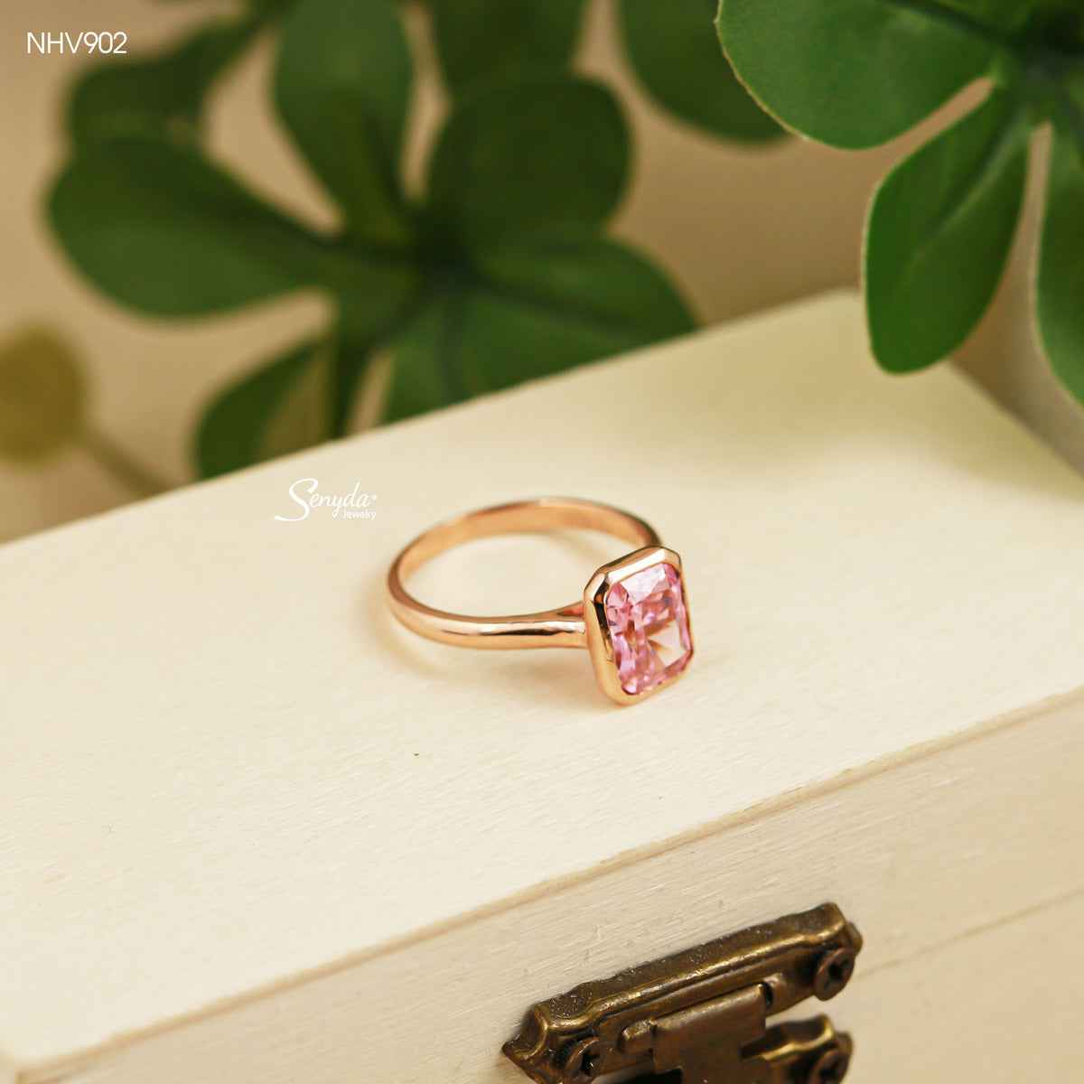 Solid yellow gold solitaire ring with a 6x8mm pink radiant-cut cubic zirconia in a smooth bezel setting