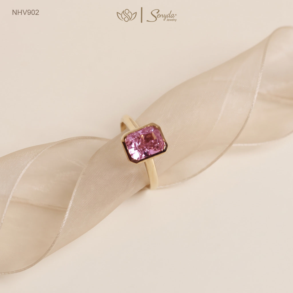 Solid yellow gold solitaire ring with a 6x8mm pink radiant-cut cubic zirconia in a smooth bezel setting