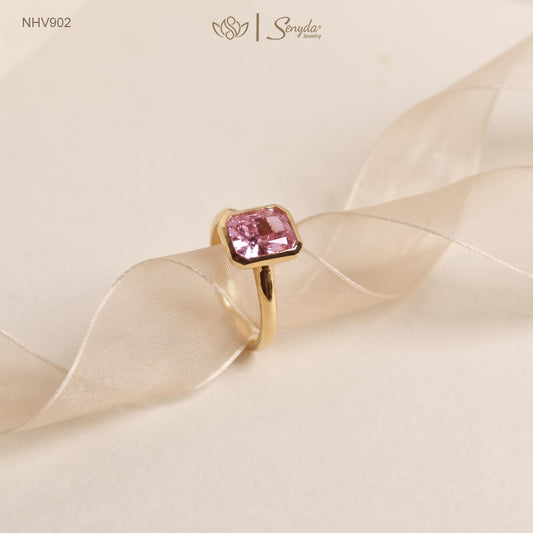 Solid yellow gold solitaire ring with a 6x8mm pink radiant-cut cubic zirconia in a smooth bezel setting