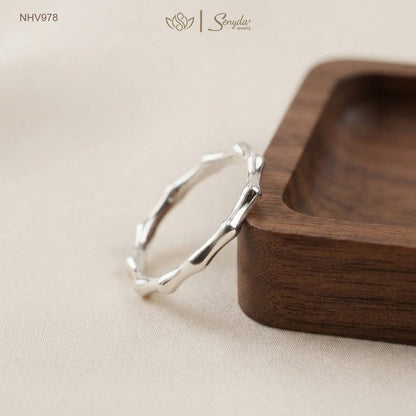 Dainty 10K solid gold bamboo joint stacking ring with an organic textured node design.